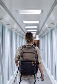 Traveler walking through an airport terminal beginning a sacred journey